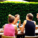 **

A vibrant photo of a "Kaffeeklatsch" (coffee gathering) in a neighbor's garden in Berlin. Several people are laughing while drinking coffee. In the background, kids are playing. The weather is sunny and warm, with a typical "Berliner Balkon" covered in flowers visible. Focus on conveying a strong sense of community and friendly interaction. The style should be realistic, as if capturing a candid moment.

**